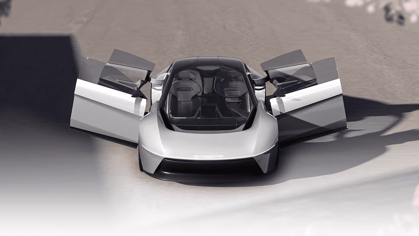 Chrysler Halcyon Concept car parked in desert landscape, sleek design, expansive glass canopy reflecting sunset.
