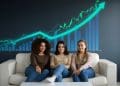 Three women crypto investors sitting together with rising investment chart, focusing on long-term wealth strategies.