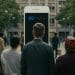 A visual representation of Meta's Community Notes, showing diverse individuals engaging with a large Meta-branded smartphone screen in a public setting. The image reflects the idea of community-driven moderation and public involvement in content review and fact-checking on Meta platforms.