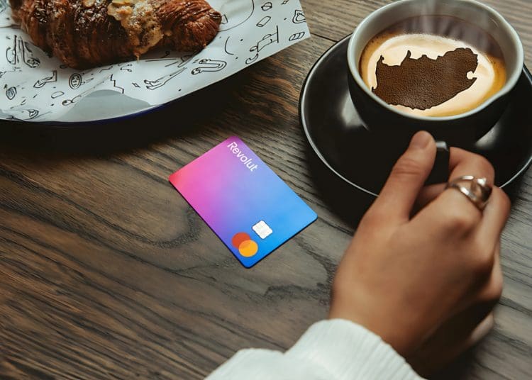 Revolut card on table with coffee cup showing South Africa map – symbolizing potential Revolut launch in South Africa