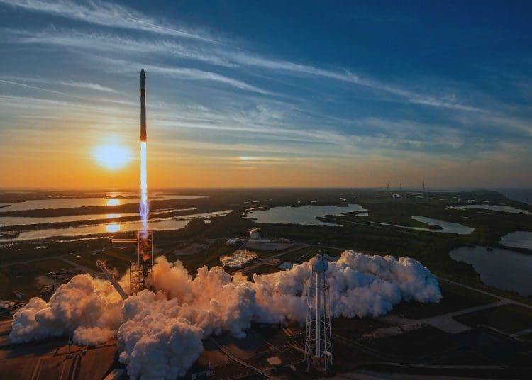 SpaceX Falcon 9 rocket launching Crew-10 mission at sunset with smoke and flames