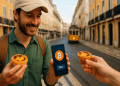 Digital nomad in Lisbon buying a pastel de nata using Bitcoin on his phone with a yellow tram in the background