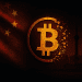 Fractured Bitcoin symbol dissolving in front of the Chinese flag and Shanghai skyline, symbolizing China's 2025 crypto ownership ban.