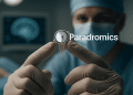 Surgeon holding a high-resolution brain implant device with microelectrodes during neural interface testing.