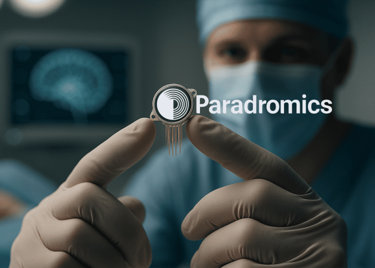 Surgeon holding a high-resolution brain implant device with microelectrodes during neural interface testing.