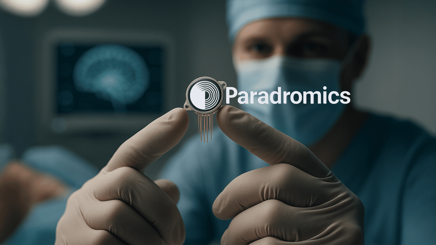 Surgeon holding a high-resolution brain implant device with microelectrodes during neural interface testing.