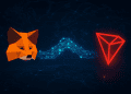 MetaMask fox logo connecting with TRON logo via glowing blockchain bridge, symbolizing global interoperability in Web3.