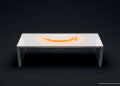 A sleek white smart table surface featuring a glowing orange Amazon smile logo surrounded by minimalist geometric etched patterns.