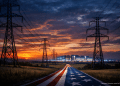 Photorealistic AI-generated image of high-voltage power transmission towers leading across a rural American landscape toward a brightly lit hyperscale data center at sunset, with a road styled as the American flag symbolizing national infrastructure and technological expansion.