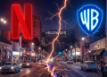 A dramatic nighttime view of Hollywood split by two opposing energy beams, one red and one blue, symbolizing industry disruption and a power shift in entertainment.