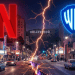A dramatic nighttime view of Hollywood split by two opposing energy beams, one red and one blue, symbolizing industry disruption and a power shift in entertainment.