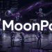 A dark, futuristic technology-themed hero image with glowing white "MoonPay" text. Small purple-faced robots (AI agents) assist on a circuit board platform under a purple nebula background with data code, representing automated finance and transaction support.