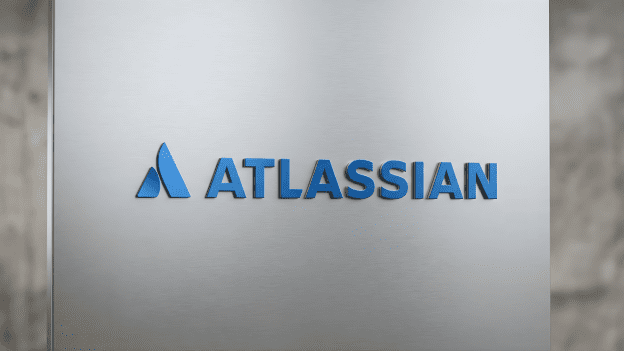Atlassian logo displayed on a sleek, brushed metal surface, representing tech innovation and AI integration.