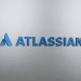 Atlassian logo displayed on a sleek, brushed metal surface, representing tech innovation and AI integration.