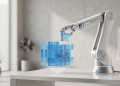A minimalist editorial photograph of a sleek robotic arm placing a cracked, translucent blue digital cube onto a holographic structure, symbolising AI fabricating task executions.
