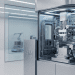 A cleanroom interior showing a futuristic Huawei chip manufacturing machine (lithography system) with a robotic assistant in the background, illustrating Huawei's effort toward silicon independence and matching TSMC.