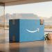 A minimalistic 3D editorial photograph of a blue Amazon Prime delivery box with embossed South African cultural symbols, featuring Table Mountain and a King Protea flower in the background.