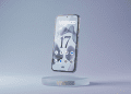 A minimalist 3D render of a flagship smartphone floating above a frosted glass pedestal displaying the Android 17 user interface on a clean, soft blue and purple gradient background.