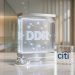 A minimalistic 3D glass and metallic display unit showing a digital DDR node network next to an institutional Citi logo block on a marble desk, representing digital depositary receipts.