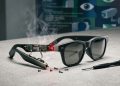 A disassembled pair of Meta smart glasses on a concrete surface, exposing internal circuits, a glowing red recording light, and rising smoke next to a precision screwdriver, symbolising a surveillance code investigation.