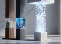 Three architectural pillars representing the pillars of corporate spend: human labor, software infrastructure, and a glowing pillar of digital AI tokens.