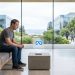 Mark Zuckerberg sitting on a bench in a minimalist Meta office, looking thoughtfully at a holographic Meta logo displaying a slow loading progress bar.