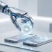 A minimalistic, high-quality photograph of a sleek metallic robotic claw placing a glowing holographic AI sphere onto an Android smartphone and an iPhone, symbolising the mobile launch of OpenClaw.