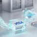 A 3D-style editorial concept image featuring the Visa logo on a sleek glass block, with glowing digital streams moving stablecoins toward an AI commerce data server.